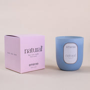 Blue amaraa natural soy wax candle with pink box on beige background